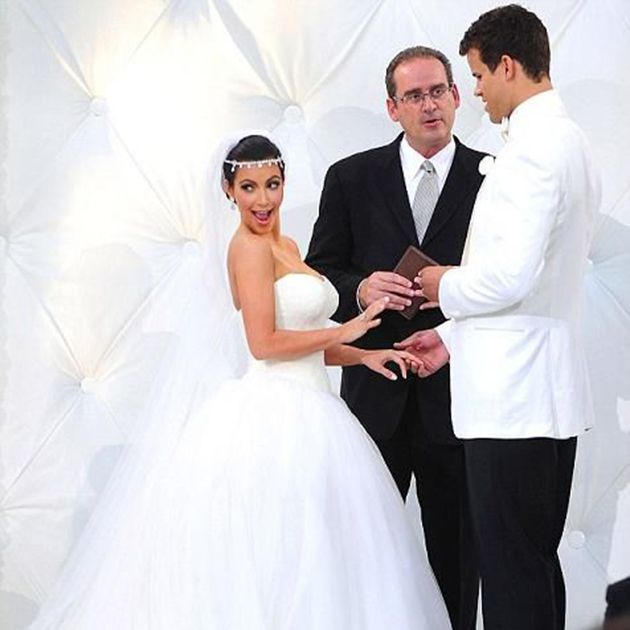 Kim Kardashian wearing a white wedding dress marries Kris Humphries.