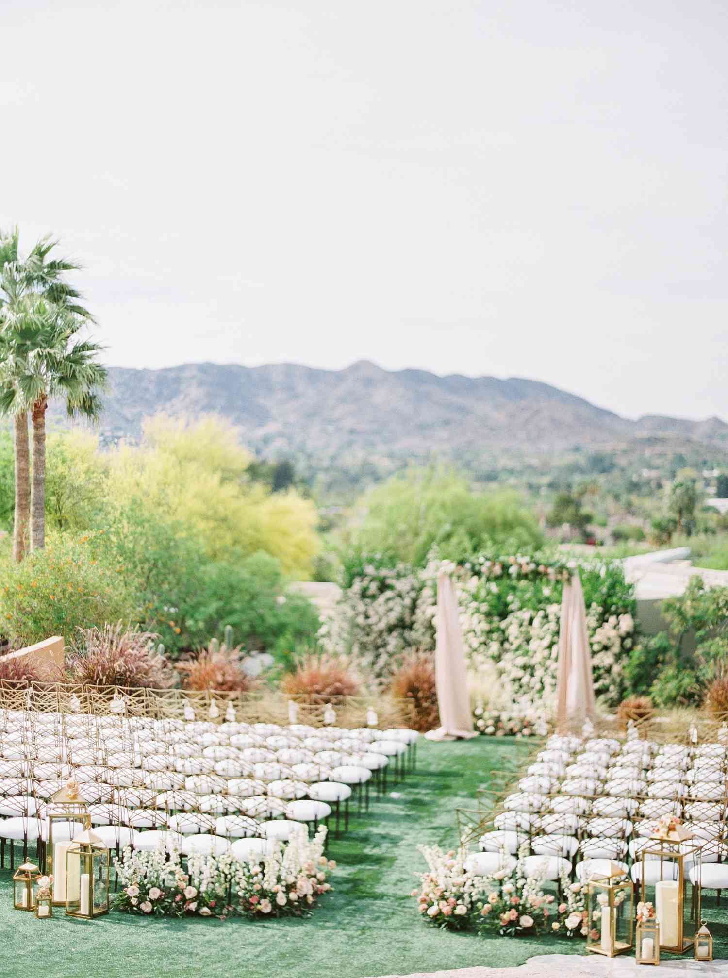 Ceremony aisle on green grass with view of mountain and trees in background