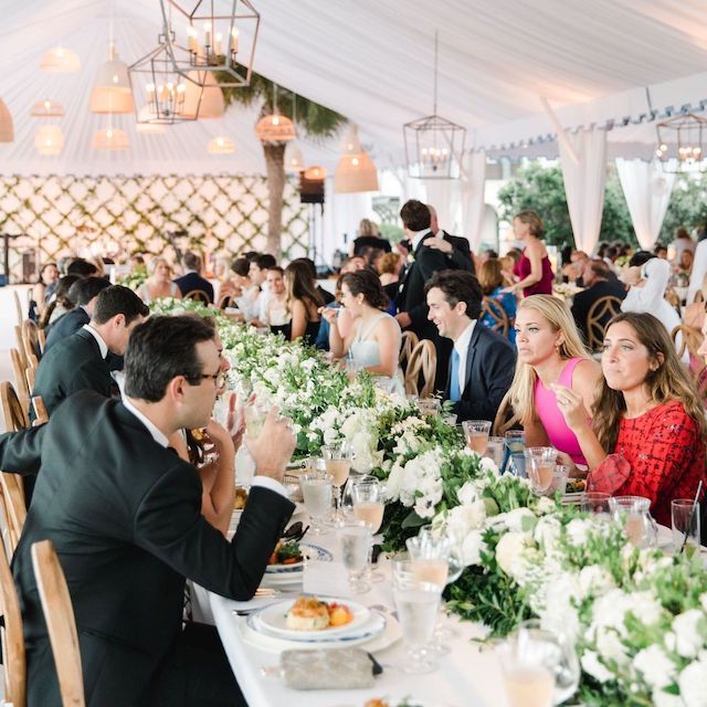Wedding guests mingle at reception table