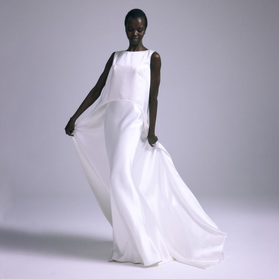 A model wearing a minimalist flowy wedding dress from Amsale