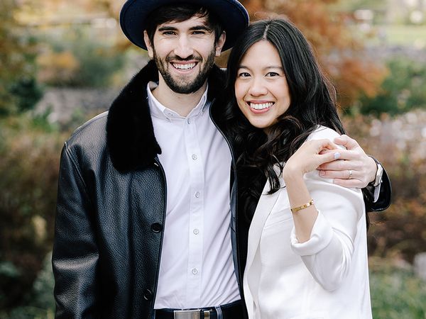 man wearing hat holding his wife and smiling for photo