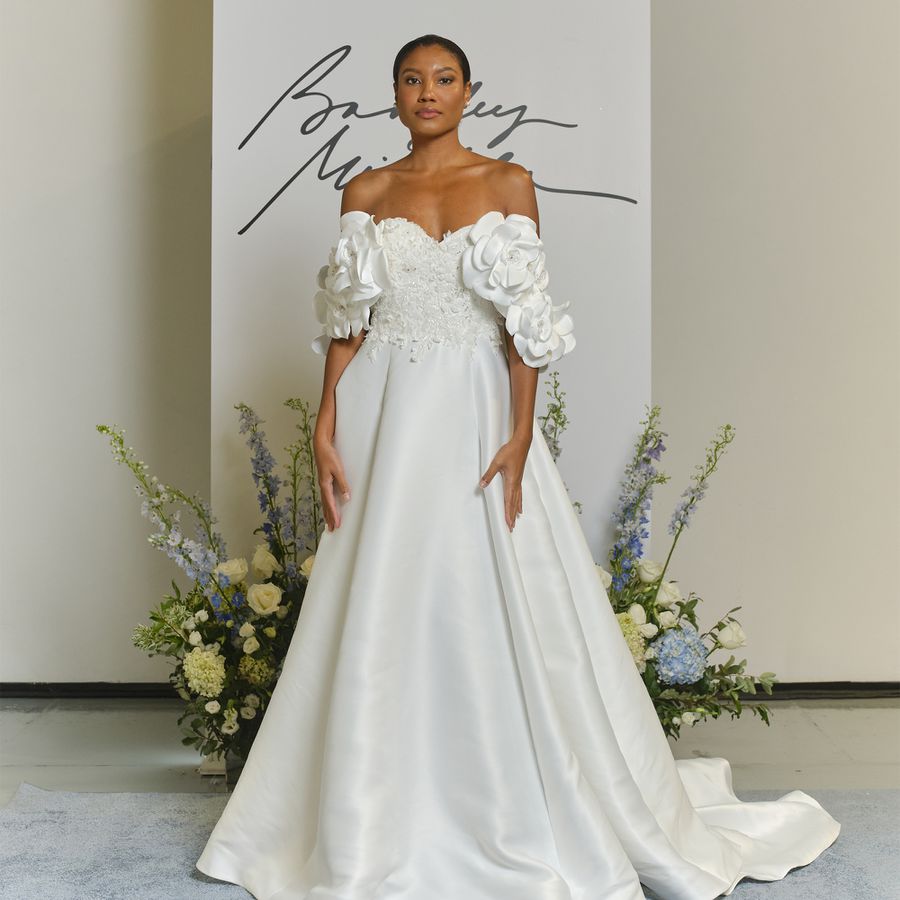 model wearing an off-the-shoulder A-line wedding gown
