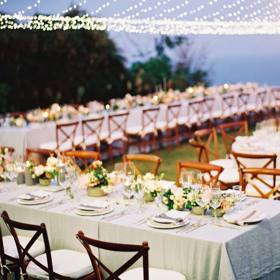 Wedding reception dinner setup with teak chairs in Bali