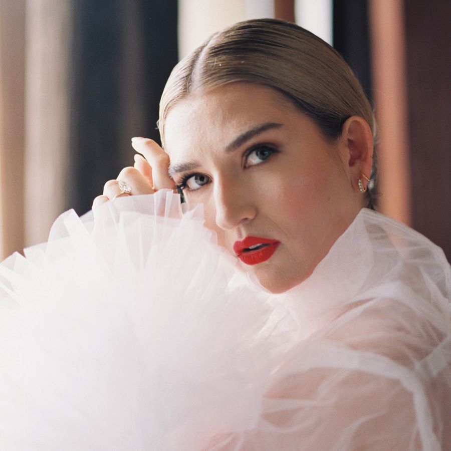 beauty shot of a bride bold red lips and a slicked back bun