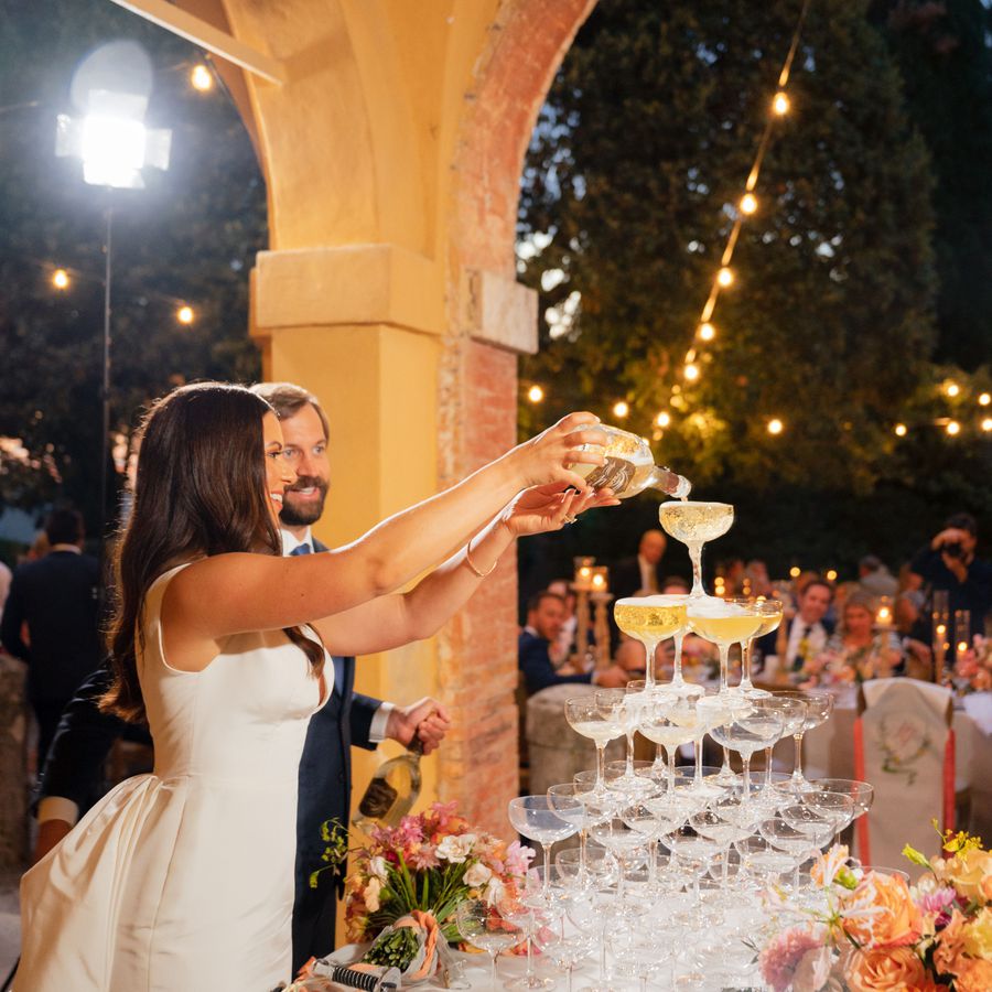 couple pouring champagne tower