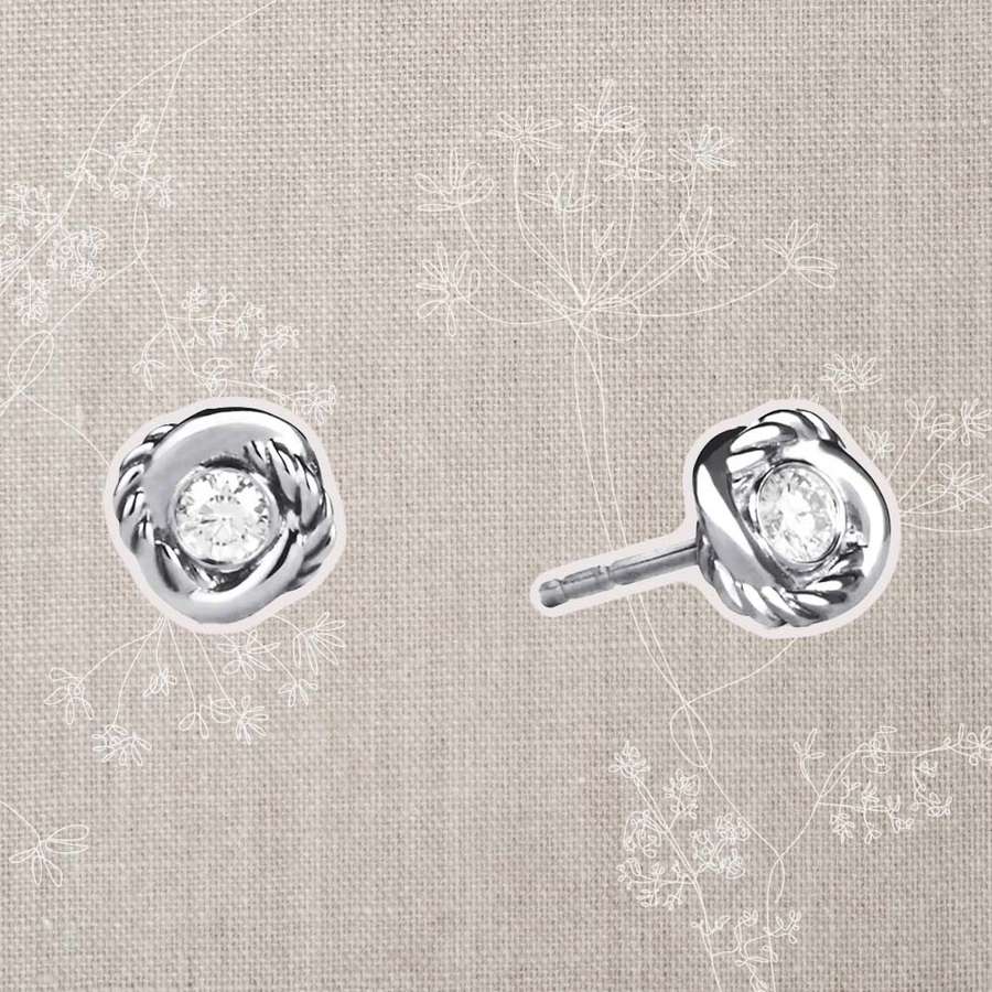 David Yurman Infinity Earrings With Diamonds on a gray textile background