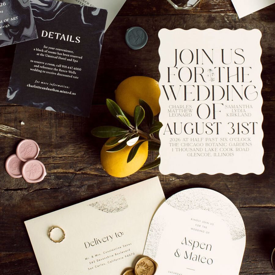 Invitations from the Minted + Brides Trends Stationery Collection displayed on a wooden table