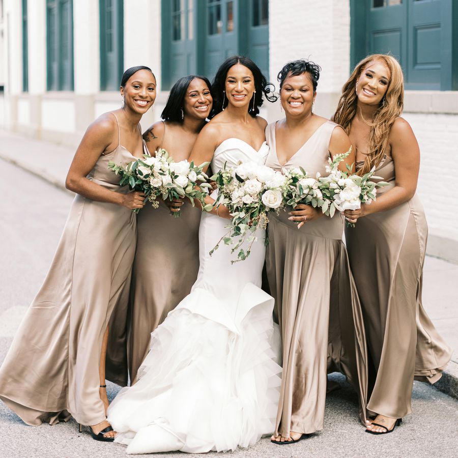 Dallas' bridesmaids wearing tan dreses and chandelier earrings