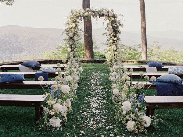 Wedding Ceremony Setup with Hydrangea-Lined Aisle and Floral Arch