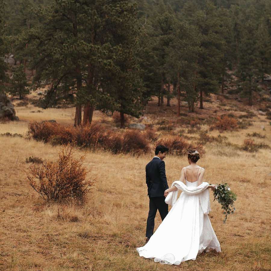 Bride and groom walking through Estes Park in Colorado, a free elopement location.