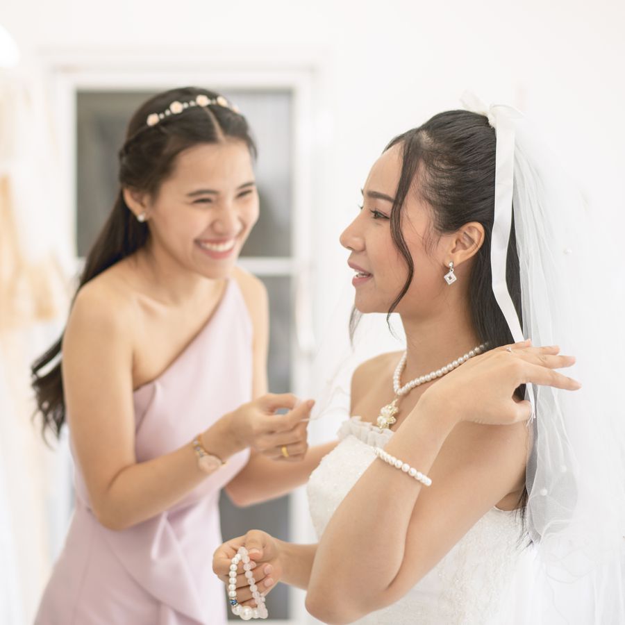 Bride getting ready for wedding with maid of honor