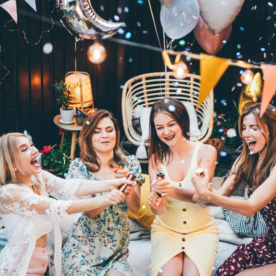 Group of girlfriends celebrating at a backyard party