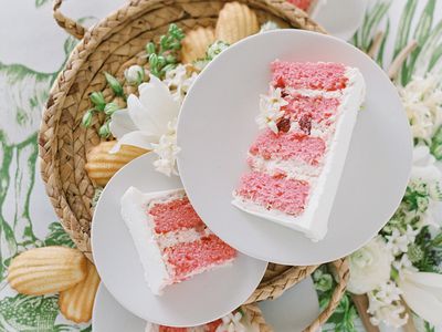 Slices of a pink wedding cake with white buttercream icing.