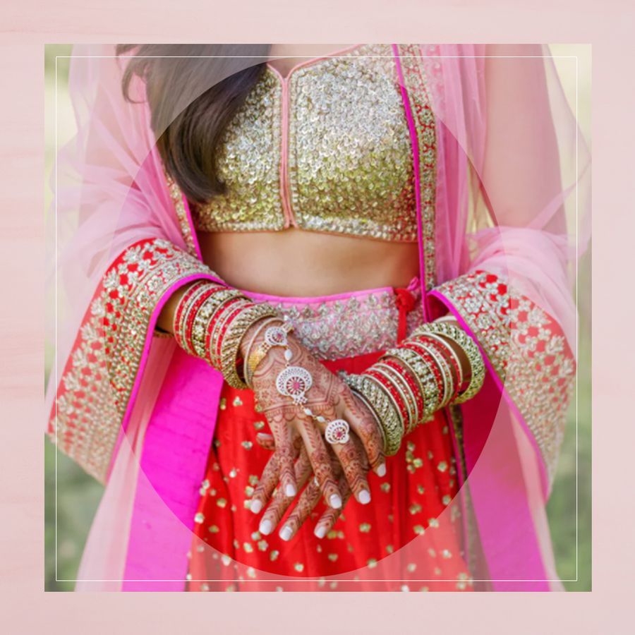 South Asian bride in sari with henna and jewelry