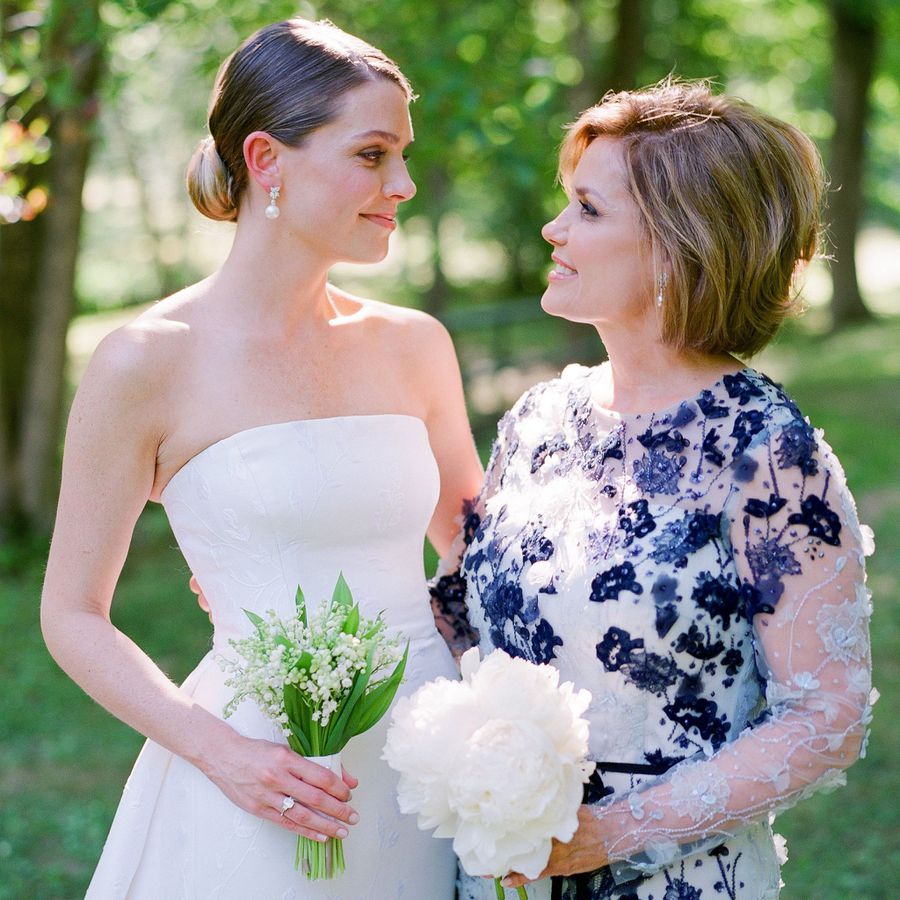 bride and mother of the bride looking lovingly at each other 