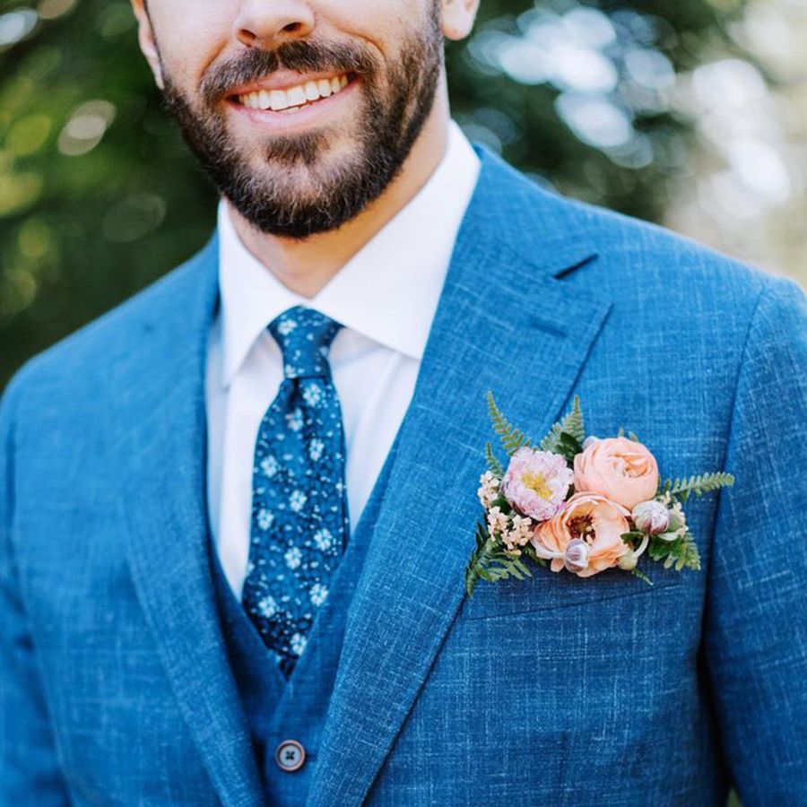 Groom in Blue Wedding Suit with Floral Pocket Square Boutonniere of ranunculus, ferns, and Anemones