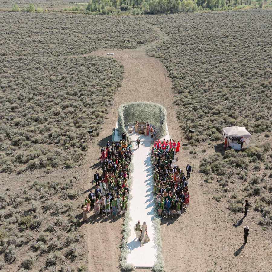 drone shot of bride walking down aisle at wedding ceremony