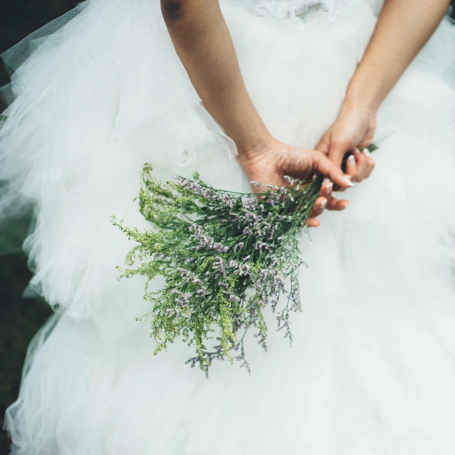 Bride in wedding dress holding a posy bouquet
