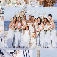 Tika's strapless lace wedding dress standing on the beach with her bridesmaids in blue dresses