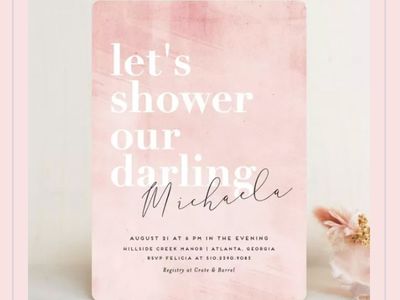 A bridal shower invitation on an off-white background with a pink border