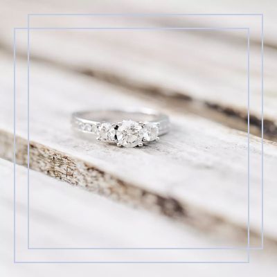 round-cut three-stone silver engagement ring