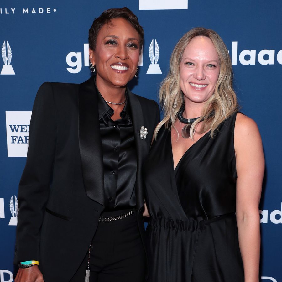 Robin Roberts and Amber Laign posing in all black on the red carpet at the 29th annual GLAAD media awards
