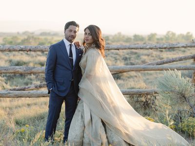 Wedding Portrait of Bride and Groom in Rustic Field with Fence Behind