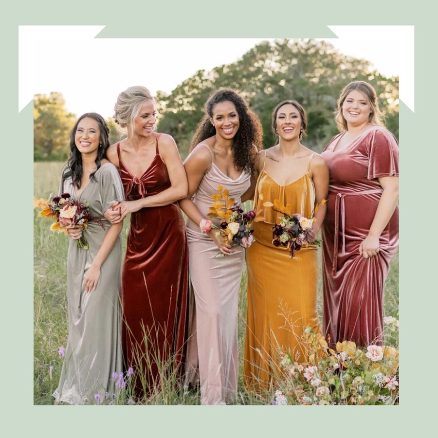 Group of bridesmaids wearing Revelry velvet dresses standing in a field on a green background
