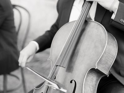 Black-and-White Photo of Man Playing Cello at Wedding Ceremony