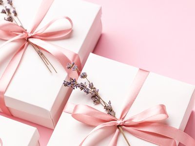 White Gift Boxes Wrapped with Pink Ribbon and Fresh Lavender Sprig