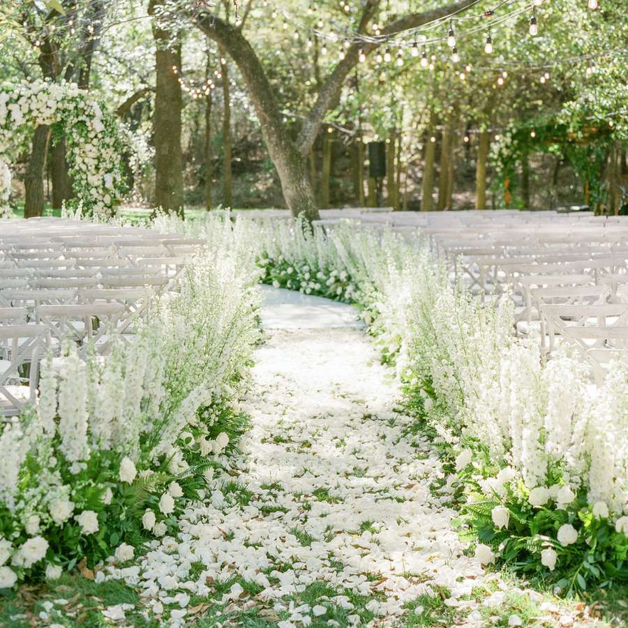 Wedding aisle lined with white flowers