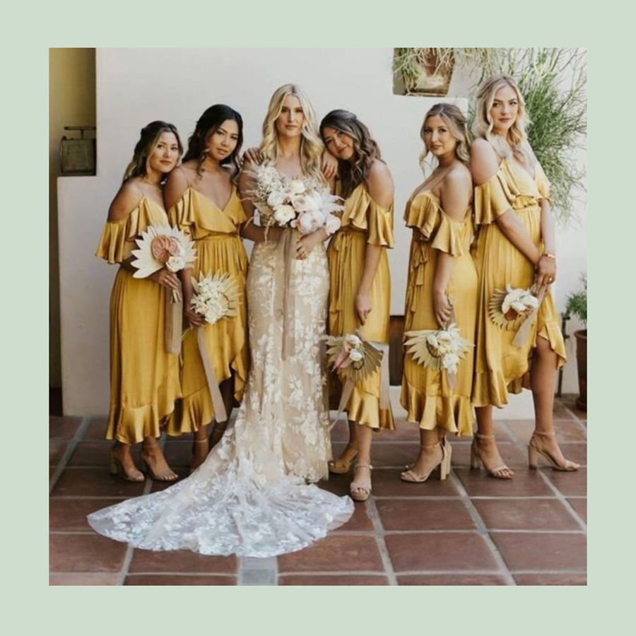 Bride surrounded by bridesmaids in yellow gowns