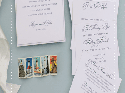 Invitation suite on blue background with lighthouse stamps