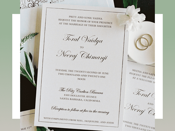 white elegant wedding invitation with black calligraphy and font